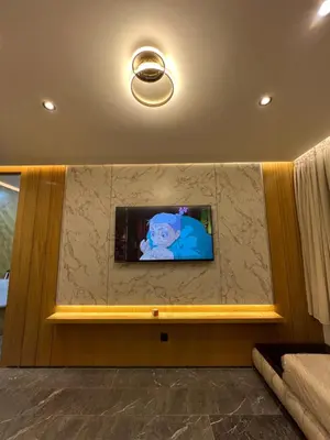 a flat screen tv on a wall in a room at Elite Garden Grand Studio Luxe in Marrakech