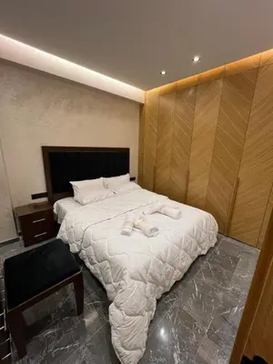 a bedroom with a large bed with towels on it at Elite Garden Grand Studio Luxe in Marrakech