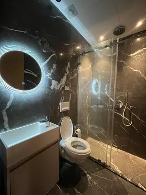 a bathroom with a toilet and a shower and a sink at Elite Garden Grand Studio Luxe in Marrakech