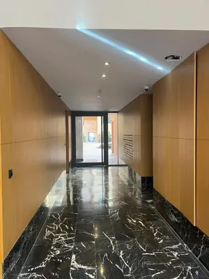 a hallway of a building with a blue light on the ceiling at Elite Garden Grand Studio Luxe in Marrakech