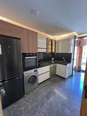 a kitchen with a washer and dryer in it at Elite Garden Grand Studio Luxe in Marrakech