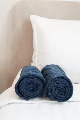 a pair of blue towels sitting on top of a bed at New cozy 2 bedroom apartment with 3 ACs close to airport and center in Marrakech