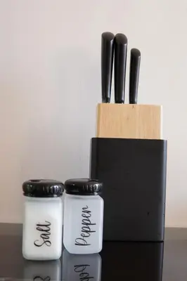 two black and white knives in a knife block at New cozy 2 bedroom apartment with 3 ACs close to airport and center in Marrakech