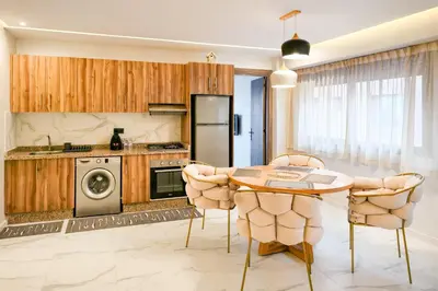 a kitchen with a table and chairs at Appartement LA 17 in Marrakech