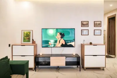 a living room with a flat screen tv on a wall at Appartement LA 17 in Marrakech