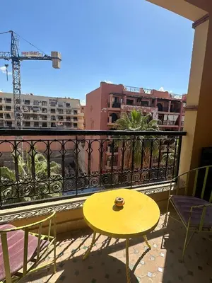 a yellow table and chairs on a balcony at Apartement in the centre in Marrakech