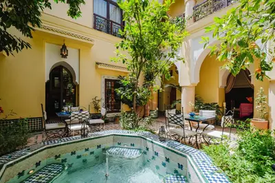 a courtyard with a swimming pool in a house at Riad Alzira Jardin Secret Au coeur De La Medina in Marrakech