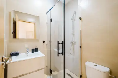 a bathroom with a shower and a toilet and a sink at Appartement de charme residence avec piscine WiFi in Marrakech
