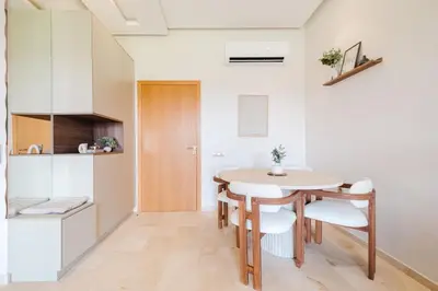 a kitchen and dining room with a table and chairs at Appartement de charme residence avec piscine WiFi in Marrakech