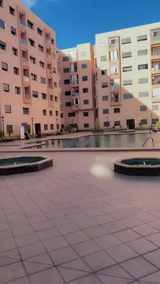 a courtyard in a city with tall buildings at jnane ali akioud Gueliz in Marrakech