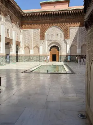 a courtyard with a swimming pool in a building at Riad Médina Bienvenue in Marrakech