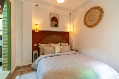 a bedroom with a bed in a room at Riad Médina Bienvenue in Marrakech