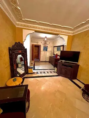 a living room with a mirror and a television at Élégance & fraîcheur Appart avec piscine in Marrakech