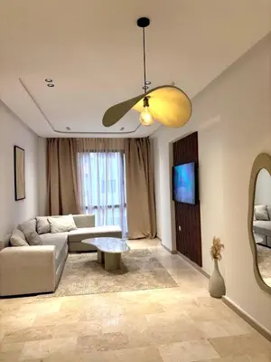 a living room with a couch and a ceiling fan at Magnifique appartement à Guéliz, résidence de luxe in Marrakech