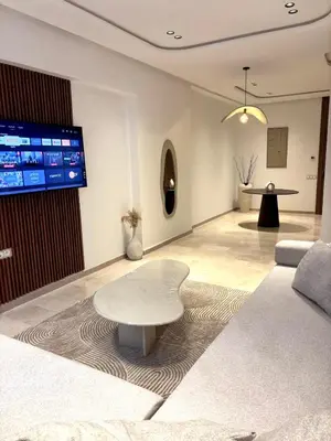 a living room with a couch and a table at Magnifique appartement à Guéliz, résidence de luxe in Marrakech