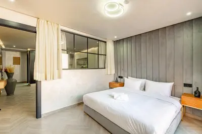 a bedroom with a large bed and a large window at AYLAL Marrakech in Marrakech