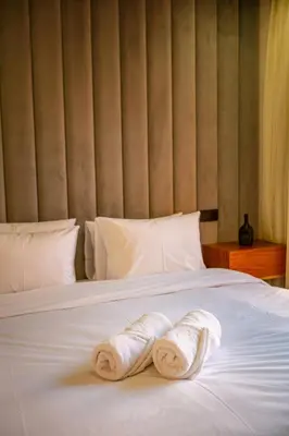 two towels on a bed in a hotel room at AYLAL Marrakech in Marrakech