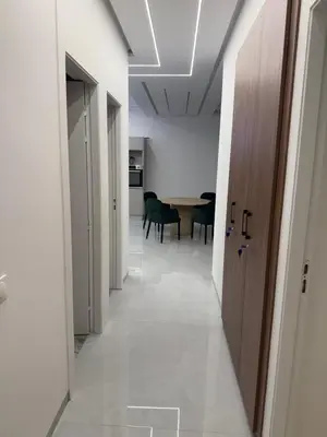 an empty hallway with a table and a door at Appartement moderne in Marrakech