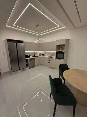 a kitchen with a table and chairs in a room at Appartement moderne in Marrakech