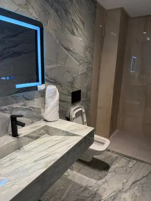 a bathroom with a marble sink and a toilet at Appartement moderne in Marrakech