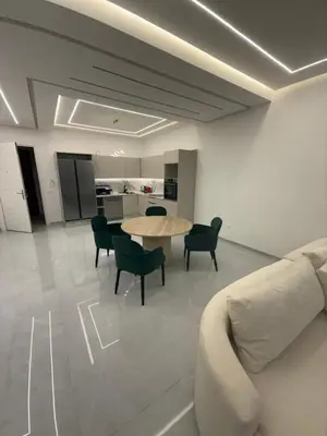 a living room with a couch and a table and chairs at Appartement moderne in Marrakech