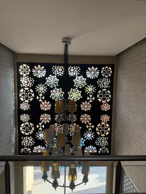 a chandelier hanging from a wall with a picture at Villa argan in Marrakech