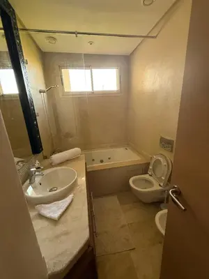 a bathroom with a sink and a toilet and a tub at Villa argan in Marrakech