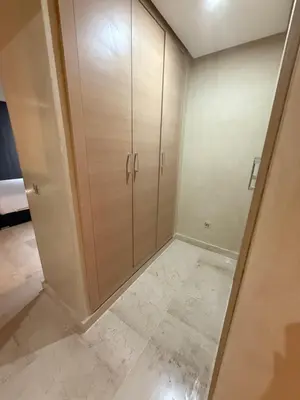 a large closet with wooden cabinets in a room at Villa argan in Marrakech