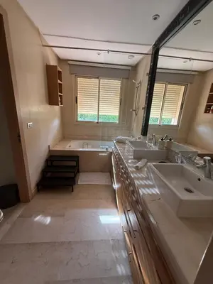 a large bathroom with two sinks and a tub at Villa argan in Marrakech