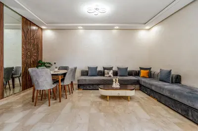 a living room with a couch and a table at Chic 2BR apartment wifi balcon in Marrakech