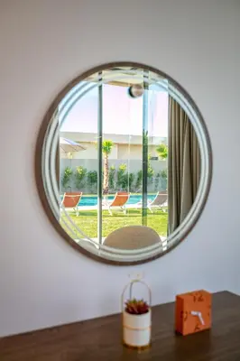a mirror on a wall with a view of a pool at Villa Luxe Neuve , Piscine XXL , Sans vis-à-vis in Marrakech
