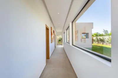 a hallway of a house with white walls and a window at Villa Luxe Neuve , Piscine XXL , Sans vis-à-vis in Marrakech