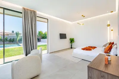 a bedroom with a bed and a large window at Villa Luxe Neuve , Piscine XXL , Sans vis-à-vis in Marrakech