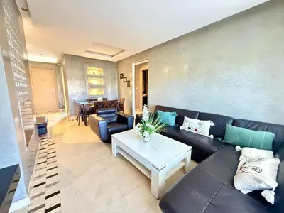 a living room with a couch and a table at Appartement with a view on the pool in Marrakech