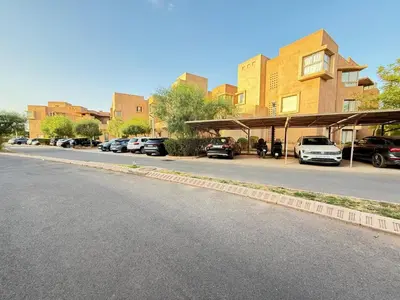 a parking lot with cars parked on the side of a street at Appartement with a view on the pool in Marrakech