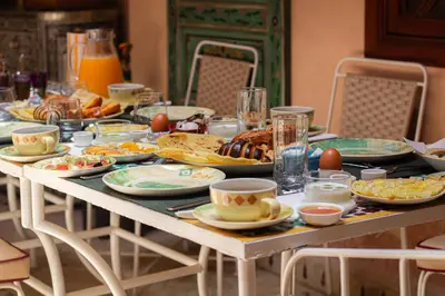 a table with plates of food on it at Riad Jamaique - Marrakech in Marrakech