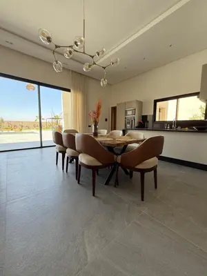 a dining room with a table and chairs at Villa ALIYAH in Marrakech