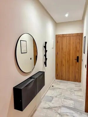 a hallway with a mirror and a door at Elegant & Cozy Stay in Center in Marrakech