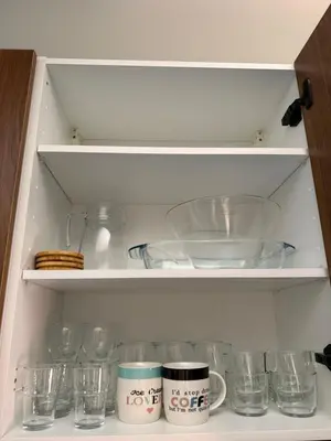a cupboard filled with dishes and glasses at Elegant & Cozy Stay in Center in Marrakech