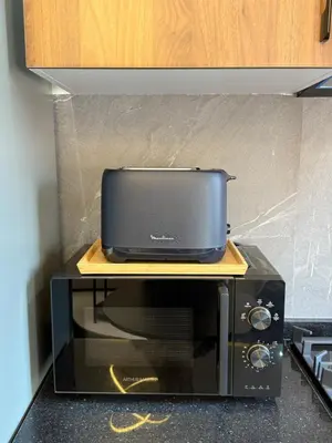 a microwave oven with a tv on top of it at Elegant & Cozy Stay in Center in Marrakech