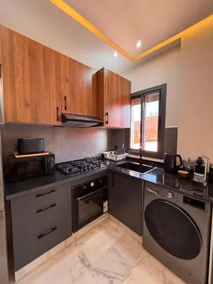 a kitchen with a stove and a sink at Elegant & Cozy Stay in Center in Marrakech