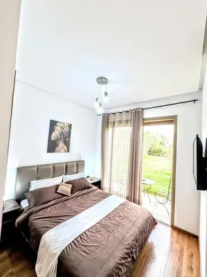 a bedroom with a large bed and a window at The Golf Pool Gardens in Marrakech