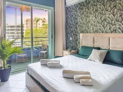 a bedroom with a large bed with two towels on it at cosy terasse apartement in Marrakech