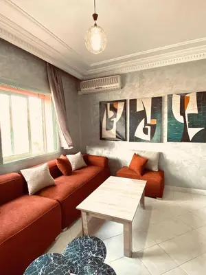 a living room with a couch and a table at cosy terasse apartement in Marrakech