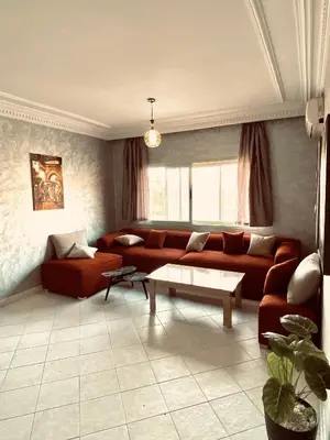 a living room with a couch and a table at cosy terasse apartement in Marrakech