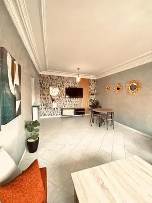 a large living room with a table and chairs at cosy terasse apartement in Marrakech