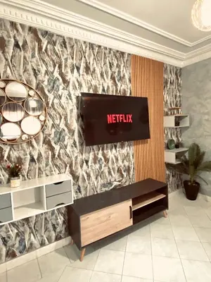 a television on a wall in a room at cosy terasse apartement in Marrakech