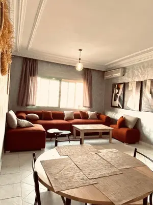 a living room with a couch and a table at cosy terasse apartement in Marrakech