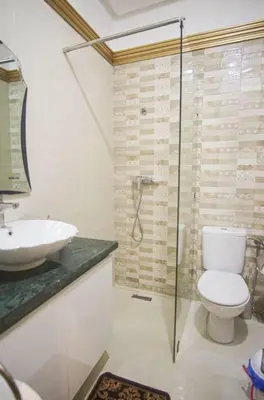 a bathroom with a toilet and a sink and a shower at Villa B with a private pool in Oulad Ikhia