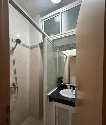a bathroom with a shower and a sink and a mirror at Appartement 2 Chambres Confortable à Jnane Awrad Calme & Sécurité in Marrakech